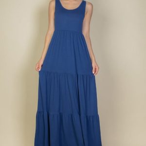 Woman wearing a tiered maxi dress with a relaxed bodice and three flowing tiers; full-length view.